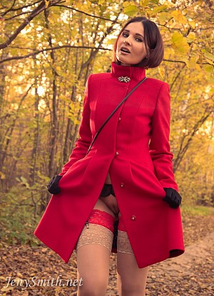 Jeny in an autumn wood takes off her coat to show her tits and legs in stockings
